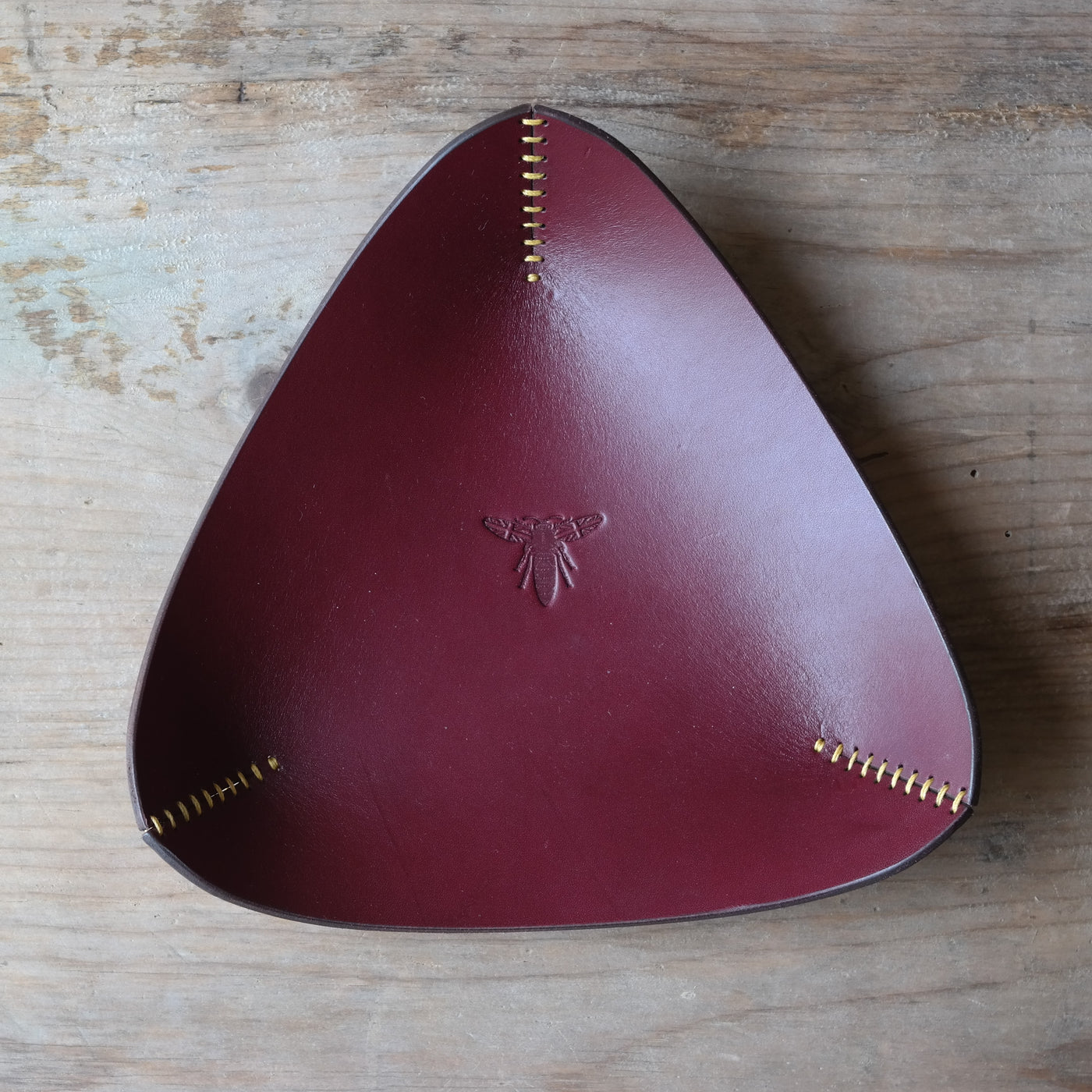 Triangle leather coin tray in deep plum British leather