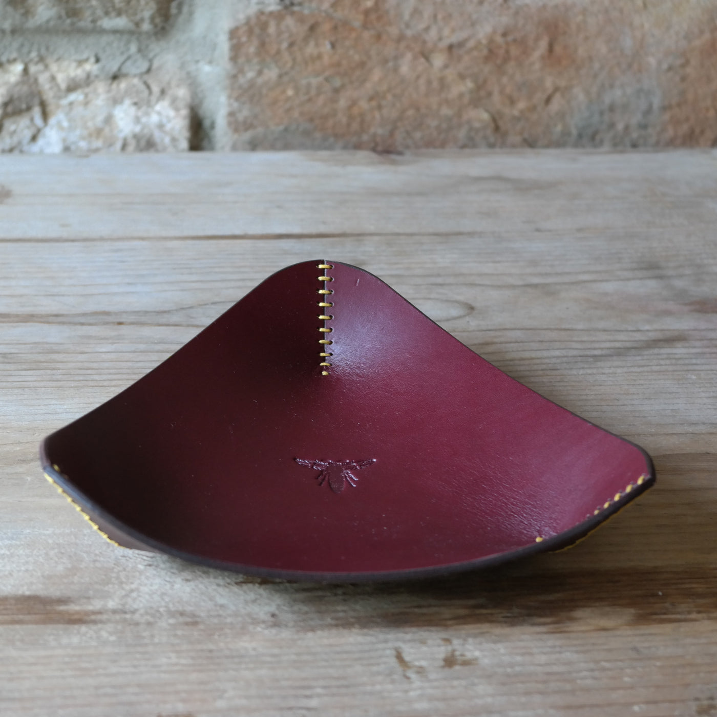 Triangle leather coin tray in deep plum British leather