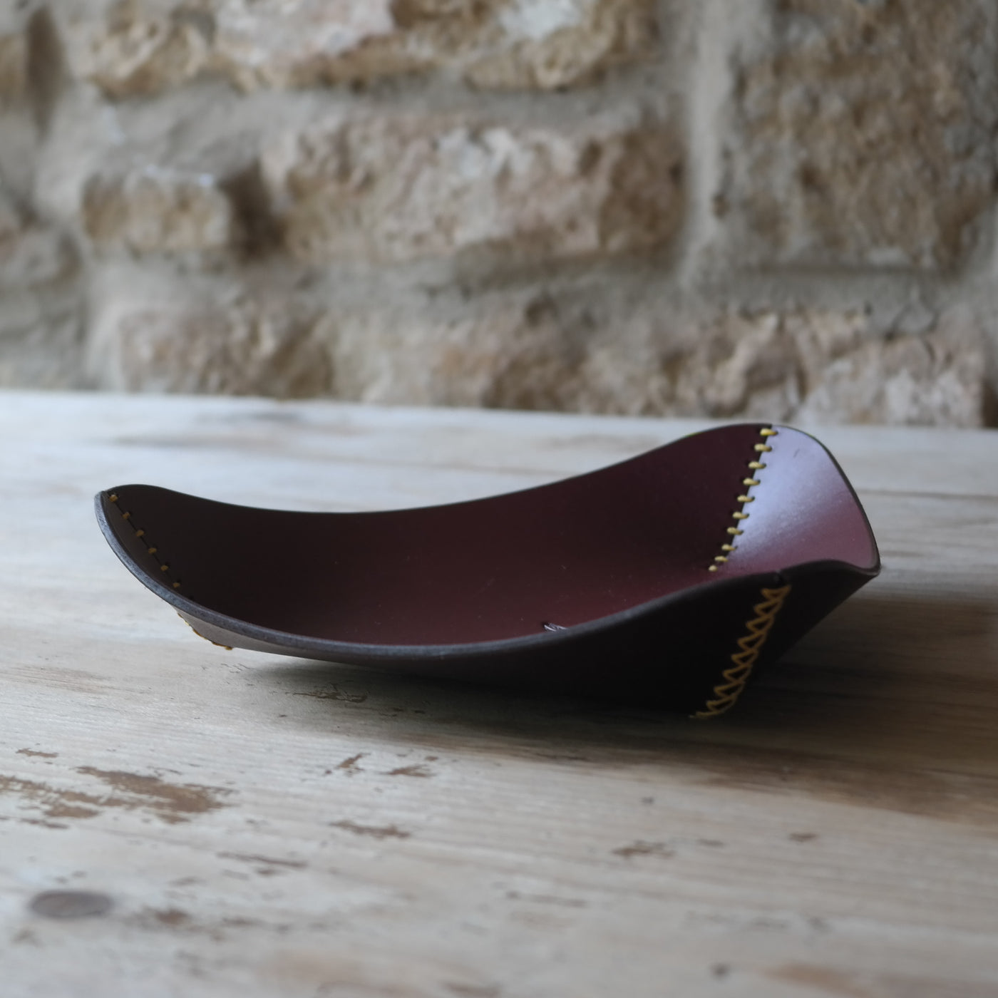 Triangle leather coin tray in deep plum British leather